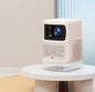 Portable mini projector with tripod on table
