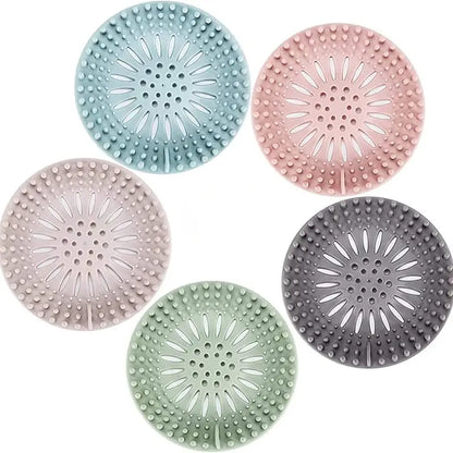 Five round silicone bath products in pastel colors on a white background